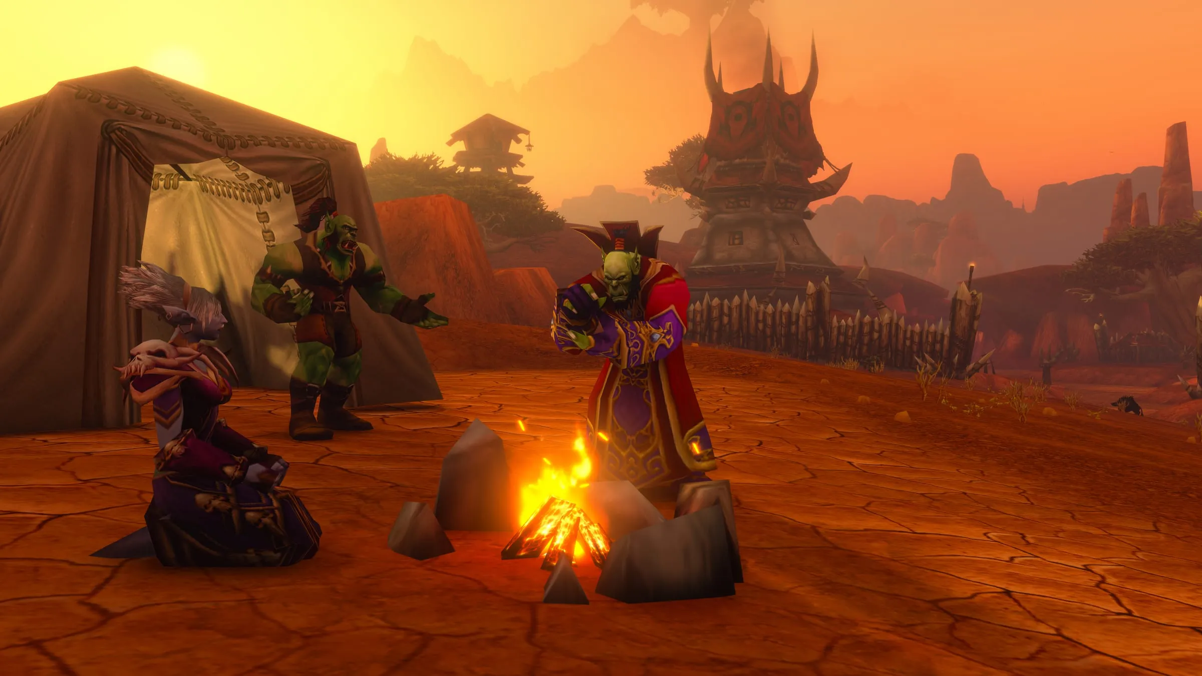 Horde players resting at a campfire beside a tent on red desert ground
