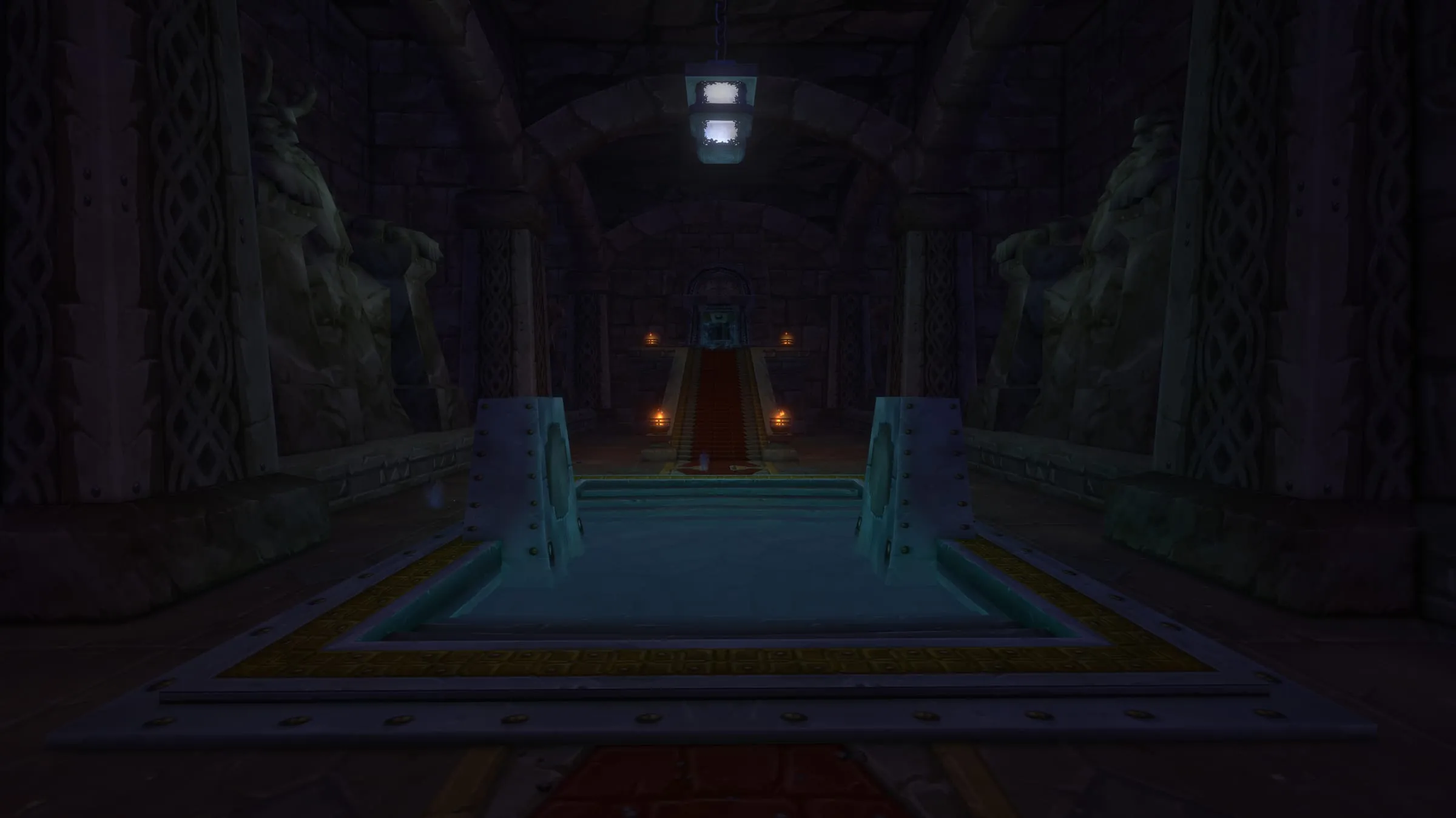A long hall lined with statues, a channel of water running its length toward a lit alcove